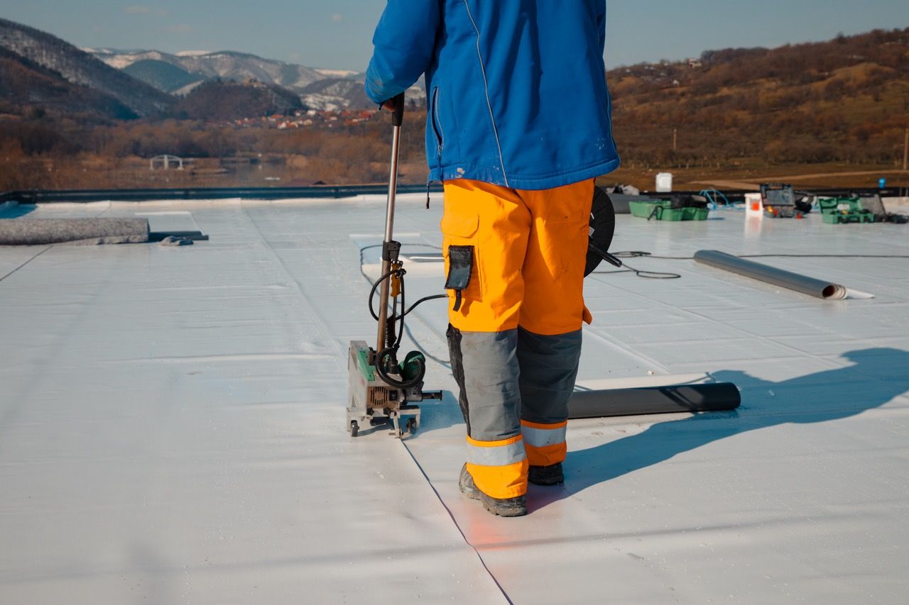 Waterproofing and insulation at construction site, waterproofing membrane preventing water penetration. Exterior vapor barrier for roof. Impermeabilización